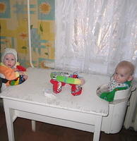 These 2 little ones are sitting in the typical 'feeding chairs' representative in Ukraine.