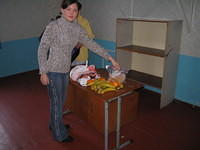 His Kids, Too! volunteer and translator, Masha lays out the fruit.