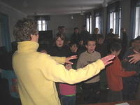 Vita and the other ladies sing along with the children, complete with the hand motions!