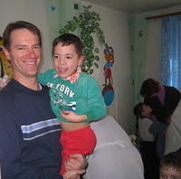 His Kids, Too! board member, Ray G. loves up on one little boy.