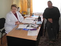 Rich sits and talks with the assistant director of the facility.