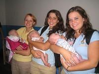 Ashley, Haley and Lydia love holding the twins and this little boy.