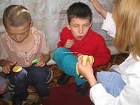 Angela gets down to this boys level to feed him.