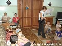 Teresa passes out candies to the kids.