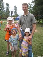 Board member, Ray G.  visits with some children.