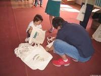 Vanya prepares the canvas bag, which each child will recieve for their clothing, and personal care bags.