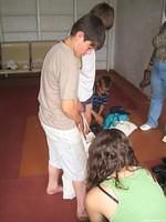 Victor allows Haley to fit him for shoes.