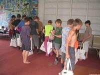 The boys go from 'station' to station to collect their items.
