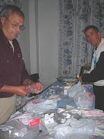 Walter and Kevin prepare first aid bags for each facility.