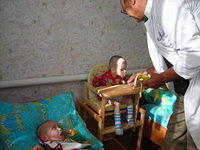 Walter feeds 2 children at a time.  Thank you Loundes Co. H.S. for the funds to purchase this fruit.