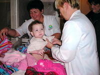 Workers and children were pleased with the great clothing.