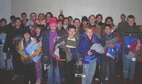 A group shot of some of the kids that received clothing, others were served later with items left for them.
