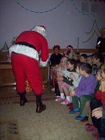 Santa passes out the gift boxes.