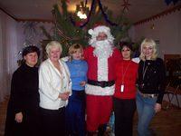 The facility director and staff enjoy a photo with Santa.