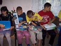 The children carefully look in their gifts.
