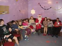 Santa takes a rest with the kids after a long day.