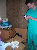 The head Dr. reviews the bottles of medicine.  Thank you Dick W. for these supplies.
