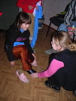 Sundy fits shoes on one little girl.