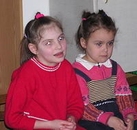 These sweet girls enjoy the singing.