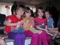 These 3 little girls love their new clothings (they are wearing them), and their dolls.