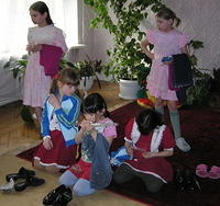 The teen girls inspect everything in the care bags.