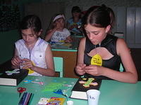 These young ladies decorate crosses.