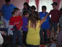 Haley passes out clothes to the older kids.