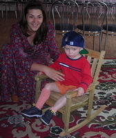 Anya helps this boy settle in the rocker.