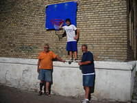 After years of watching the boys throw a basketball against this wall, we were able to erect this goal for them.