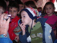 Children wait in anticipation to receive their gifts.