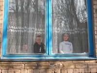 Children watch from the window as we unload the van.