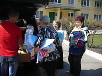The director sorts through clothing for younger children.
