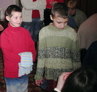 Kate tries passes out clothes to kids.