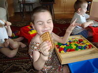 Vika enjoys her cookies and banana, thanks to Lone Oak CoC for the dresses.