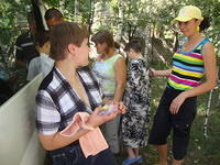 Alyssa passes out wash clothes, soap, toothbrushes and paste to the ladies.