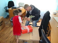 Vanya helps kids get the boxes open.