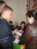 Cassie and Vanya hand out toys and candy.