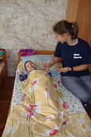 Susanna feeding a little boy.