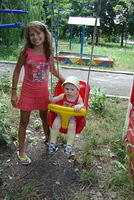 Julia helps this little boy take a swing.