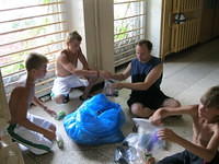 The 'campers' help put soap in the bags.