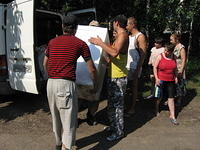 Some of the maintainence workers assist with carrying in refridgerators