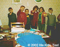 The kids pose, still in their make up from their performance, in some of the new clothing, donated items fill the room!