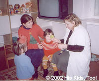 His Kids, Too! director is helping Yulia choose a toy.