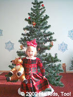 Alla in front of the 'Yolka,' Christmas tree. She loves that reindeer!