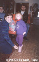 Getting dressed for leaving the orphanage.  Special boots made from fabric from the May Kay jet!!