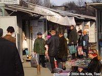 Grain is sold from metal containers at an open air market