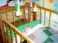 This little boy enjoys his new crib mobile, mattress, and quilt.  Special thanks to Zula McLeod for the wonderful quilts!