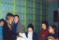  His Kids, Too! volunteer , Christina, hands out sheets to the boys.