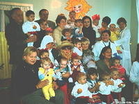 After the performance, audience members gather children for a group photo opportunity.