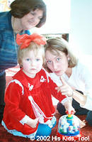 His Kids, Too! board members, Nikka and Lynn, play with this beautiful little special needs girl.